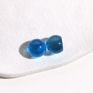 Close-up of 14mm translucent blue resin round beads for DIY jewelry and hair accessories