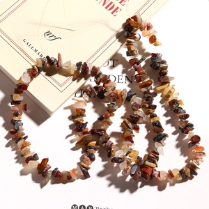 Irregular natural stone chips for DIY jewelry making laid on a vintage French book