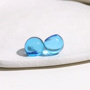 Macro shot of two 14mm royal blue translucent round resin charms for DIY jewelry making
