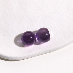 Macro detail of 14mm translucent purple resin round beads with glossy finish on display