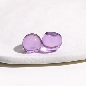 Macro shot of 14mm round translucent light purple jelly resin cabochons for DIY crafts