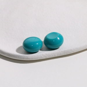 Detail of turquoise resin dome cabochons with a smooth polished finish for DIY jewelry