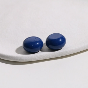 Detail of deep blue round resin cabochons with a smooth glossy finish for DIY jewelry