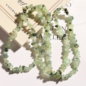 Macro detail of irregular natural green prehnite stone beads for DIY jewelry making