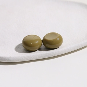Close-up of olive green resin dome cabochons for DIY jewelry and phone case crafts