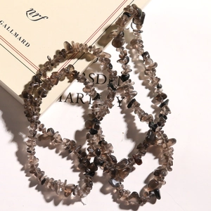Detailed close-up of natural irregular smoky quartz stone chips for jewelry making
