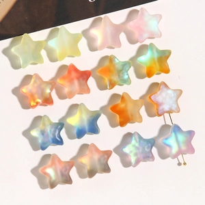 Macro view of pastel gradient star beads with iridescent matte finish for DIY jewelry