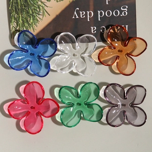 Macro view of transparent colorful acrylic four-petal flower charms for DIY jewelry making