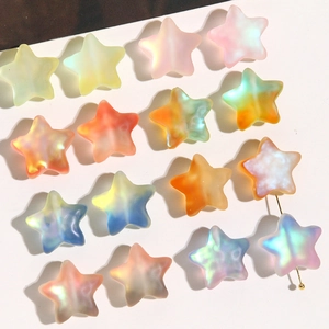 Detailed macro view of colorful gradient star beads with pearl luster for DIY jewelry