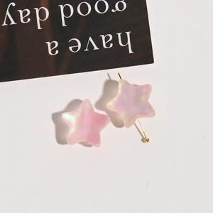Detailed view of matte star beads with pink-purple gradient and pearlescent finish
