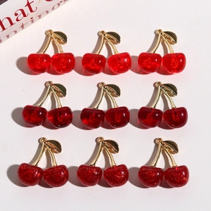 Detail of 3D cherry charms in jelly red, solid, and glitter finishes for jewelry making