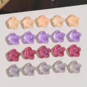 Macro view of 20 pieces glitter resin star charms for DIY earrings in four colors