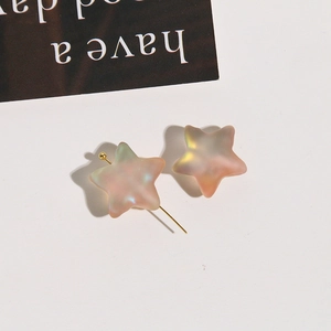 Macro detail of iridescent star-shaped beads with a matte finish for DIY jewelry