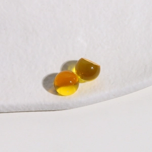 Macro view of two amber transparent 10mm resin round beads for DIY jewelry making