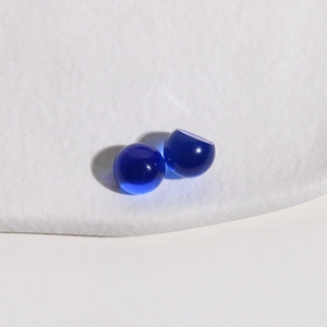 Macro shot of 10mm deep blue translucent resin cabochons with smooth rounded surface