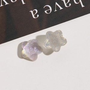 Detailed macro view of star-shaped resin studs featuring iridescent glitter finish