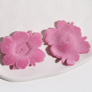 Vue macro de breloques fleurs en velours rose pour bijoux DIY et accessoires cheveux