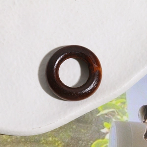 Macro shot of circular dark walnut wood pendant ring for DIY jewelry making