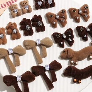 Close-up of flocked teddy bear and dachshund charms with sparkling rhinestone accents