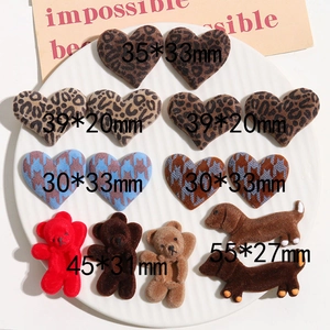 Detailed macro view of assorted flocked leopard and houndstooth heart-shaped DIY patches