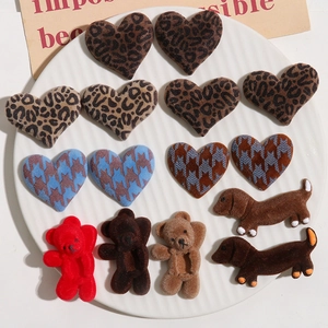 Detailed macro view of assorted flocked leopard print bear and heart DIY patches