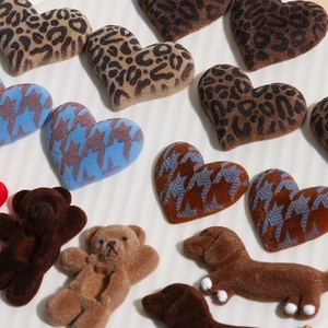 Close-up of DIY flocked charms featuring leopard print hearts and brown bear shapes