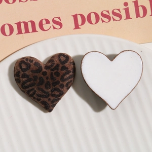 Detail of heart-shaped leopard print flocked and white resin charms for DIY jewelry making