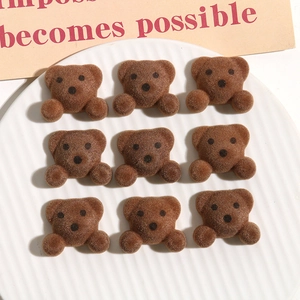 Macro detail of nine brown flocked teddy bear resin accessories for DIY hair jewelry