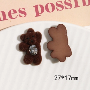 Detail of dark brown flocked bear resin charm with large rhinestone and 27x17mm size