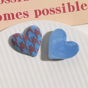 Detail of blue houndstooth flocked heart and marble resin charms for DIY jewelry