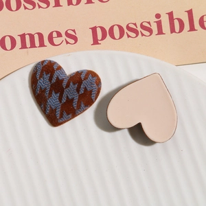 Detailed view of heart-shaped flocking accessories with houndstooth pattern and matte finish