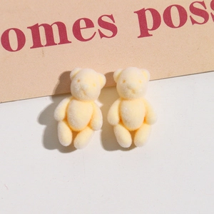 Detailed close-up of mini yellow flocked bears for DIY jewelry and hair accessories
