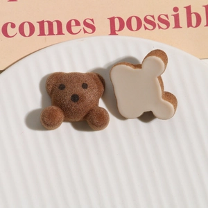 Macro detail of brown flocked bear resin charms for DIY jewelry and hair accessories