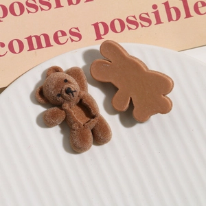 Macro detail of brown flocked bear charms for DIY accessories showing front and back textures