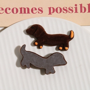 Detail of flocking brown dachshund charm with orange accents for DIY craft accessories