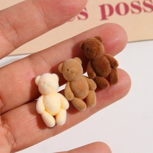 Close-up of three mini flocked bear DIY accessories in cream, light brown and dark coffee