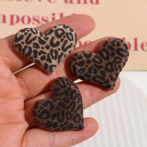 Macro view of flocking leopard print heart charms for DIY hair accessories and crafts