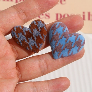 Macro detail of flocked heart charms with star patterns for DIY hair accessories and phone cases