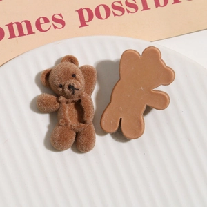 Detailed close-up of brown flocked bear charms for DIY hair accessories and phone cases