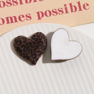 Macro shot of leopard print velvet heart patches for DIY accessories and crafts