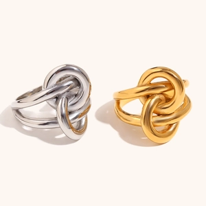 Double layered knotted wrap ring in 18K gold and silver finish on a clean background