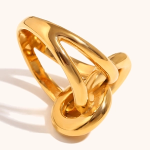 Detail of 18K gold-plated stainless steel double-layered knotted ring with polished finish