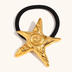 Starfish hair tie with 18K gold plated pendant and black elastic band on plain background