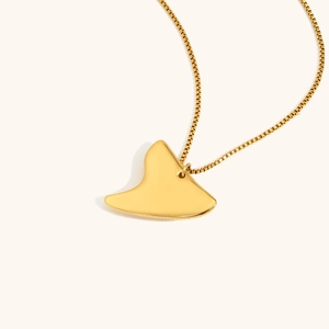 Polished 18K gold plated stingray pendant necklace with elegant box chain on beige background