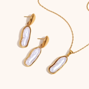 Detailed close-up of baroque pearl necklace and earrings in 18K gold-plated stainless steel