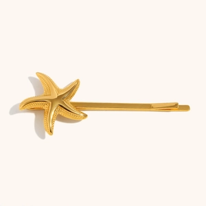 Macro detail of 18K gold-plated starfish hair clip with fine matte texture and sleek finish