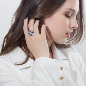 Elegant silver ring with AAA blue sapphire and zircon stones on female model wearing white suit