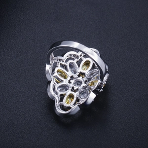 Macro shot of silver ring featuring intricate filigree design and marquise-cut zircon stones