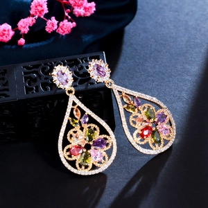 Detail of vintage teardrop earrings with multicolor zircons and champagne gold plating