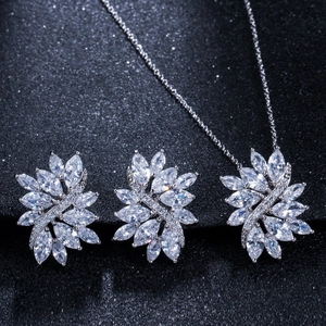 Macro shot of silver zircon jewelry set with marquise cut stones on grey background